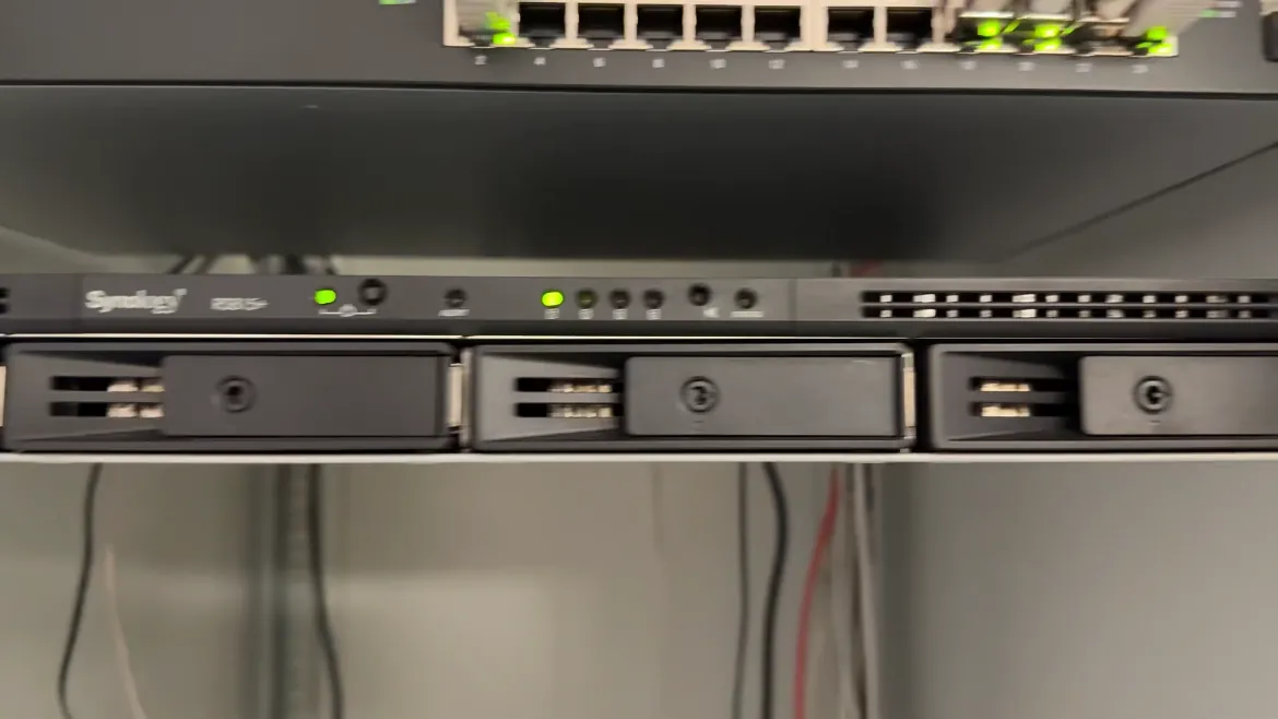Synology RS815+ back in the rack with green power and status lights on